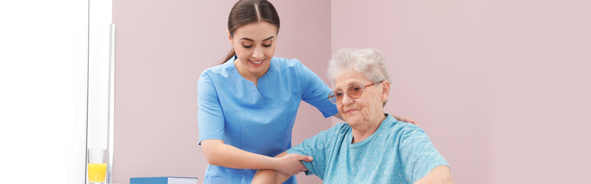 caregiver holding the elderly while standing