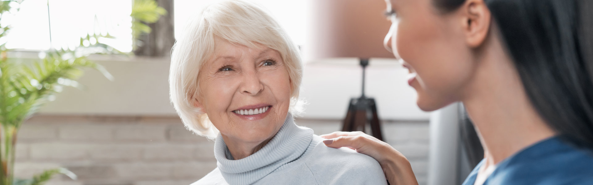 cheerful elderly and caregiver