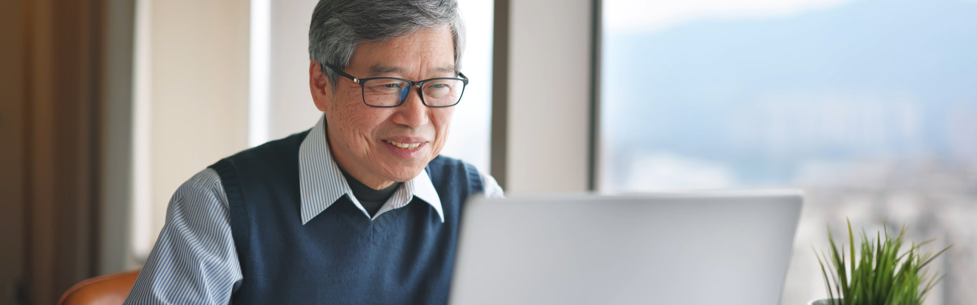 elderly man using his laptop