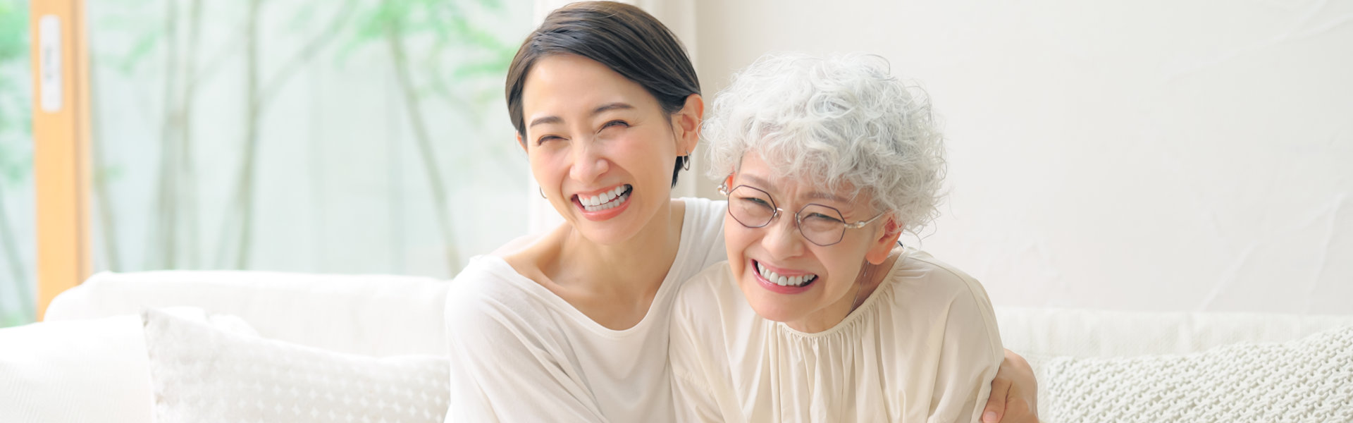 happy elderly with her aide hugging her